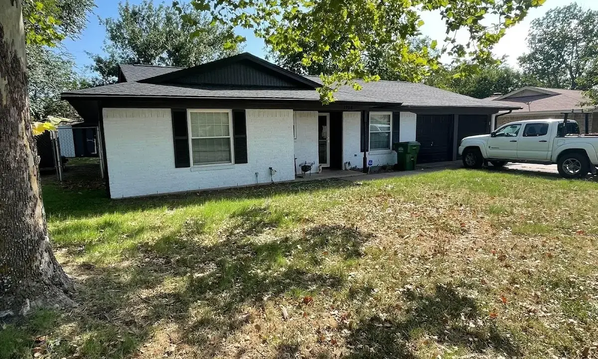 Professional roofing crew working on a residential roof in Finley